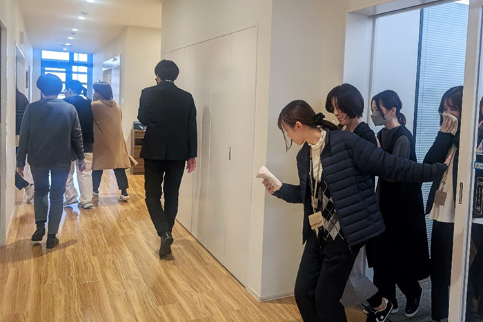 口元にハンカチを当てながら、冷静に避難する社員たち